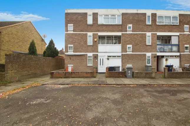 Three-storey brick townhouse terrace on a residential street